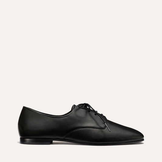 The Billie Derby - Black Nappa by Margaux, a classic black leather lace-up dress shoe, shown in a side view against a plain white background.