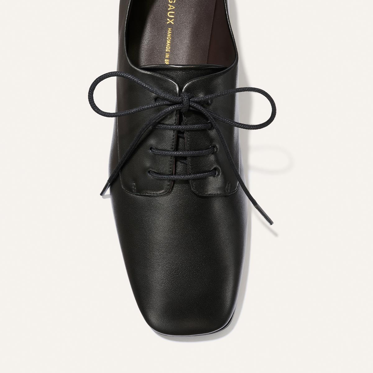 The Billie Derby - Black Nappa by Margaux, a black leather lace-up dress shoe with a square toe, is shown from above on a light background.