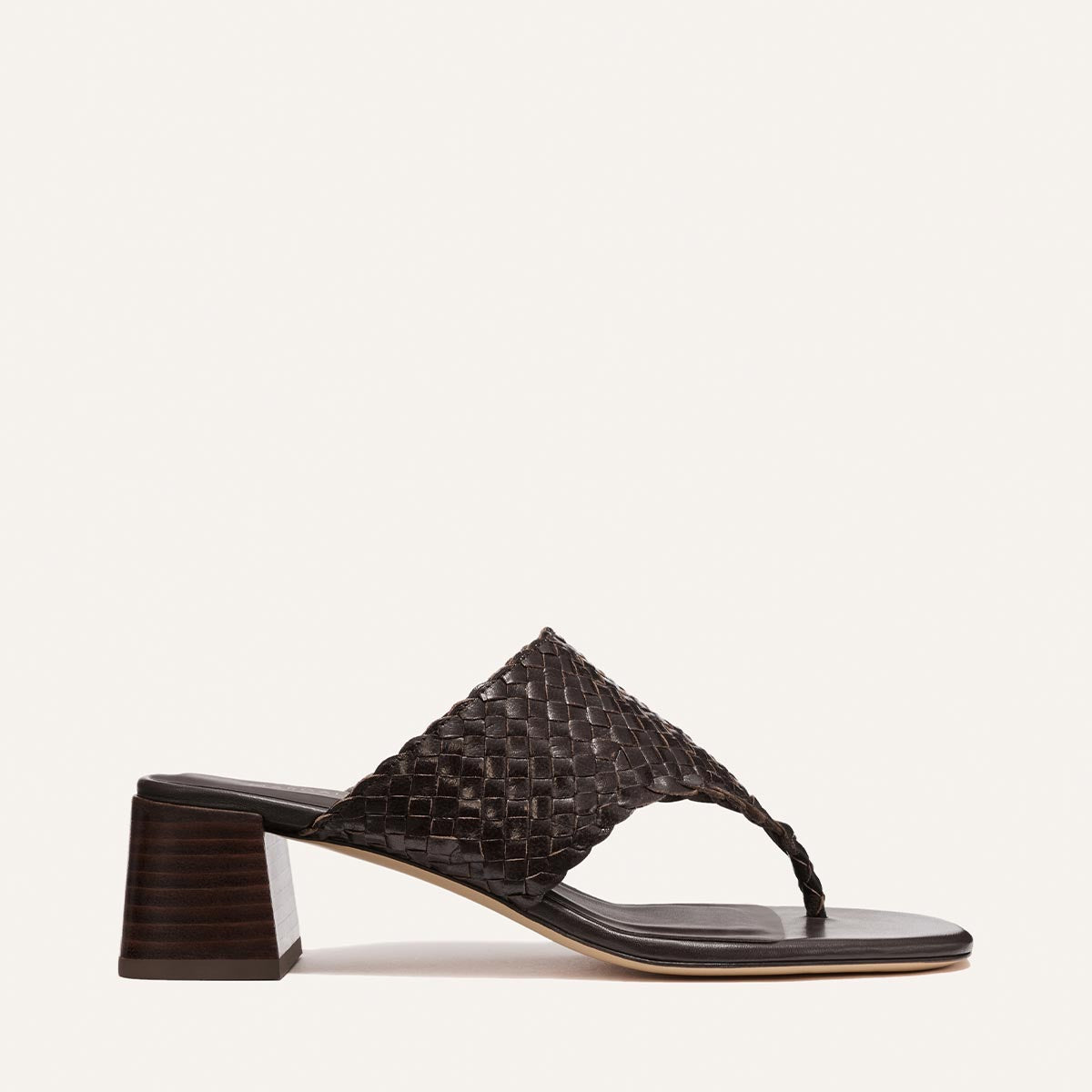 Brown woven sandal on a light beige background
