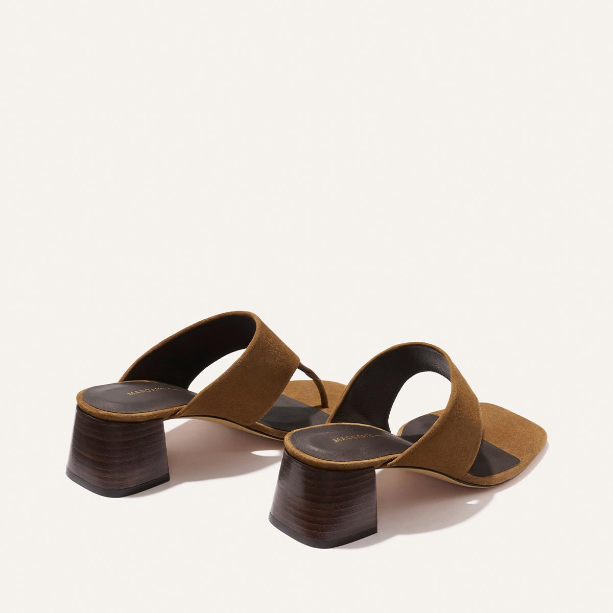 The Deia 50 - Nutmeg Suede by Margaux: brown suede heeled sandals with two wide straps and chunky wooden block heels, shown on a plain white background.