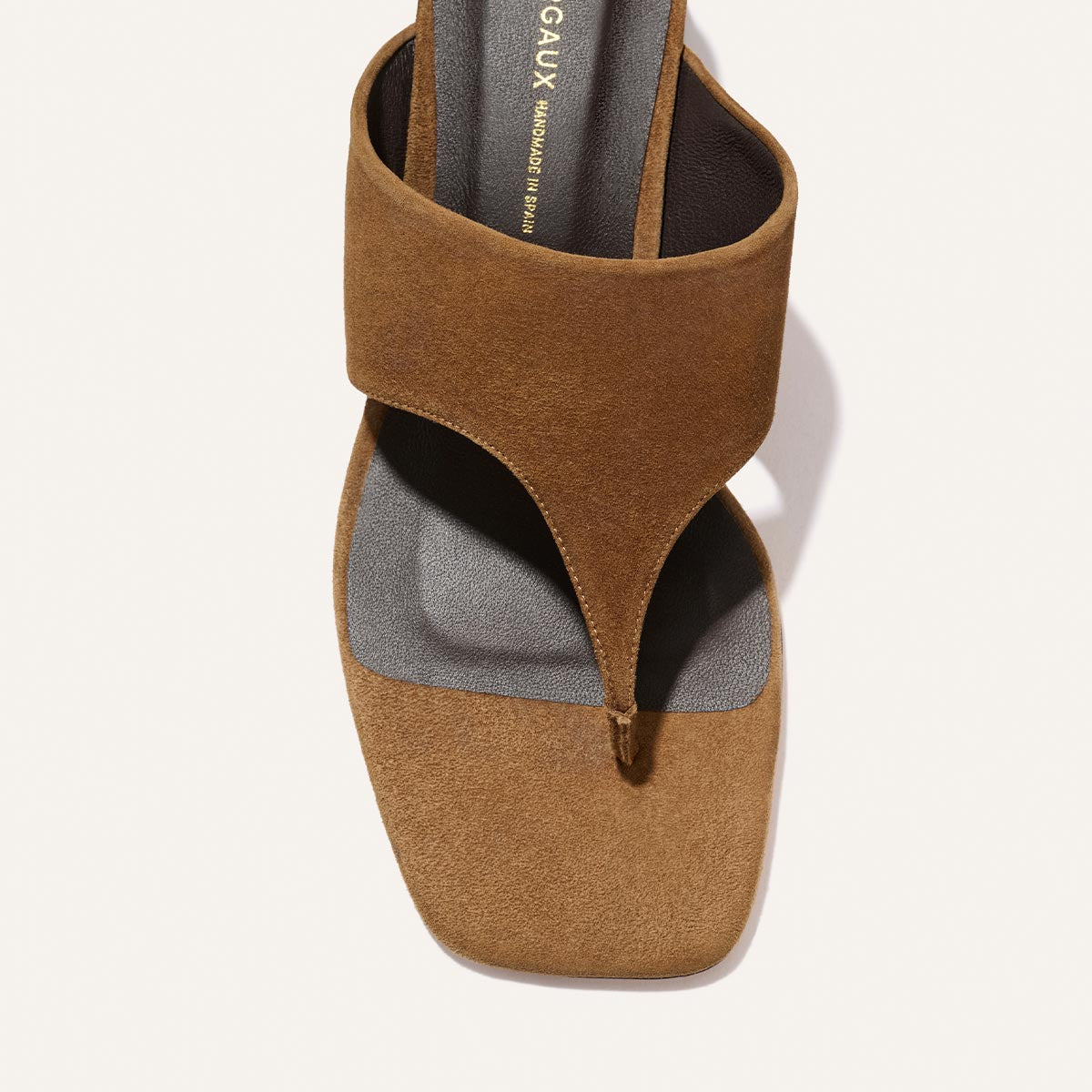 Margaux's The Deia 50 in Nutmeg Suede is a brown sandal with a wide strap, toe loop, square open toe, and dark cushioned footbed.