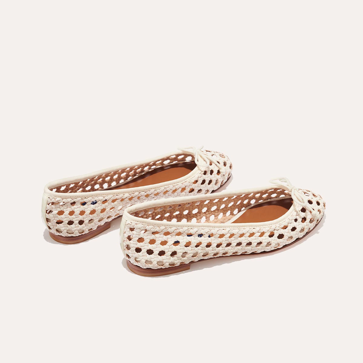 The Demi - Ecru Woven Leather by margaux-development: handmade white woven leather ballet flats with cutout details and small front bows, shown on a plain light background.