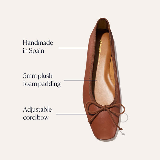 The Fonteyn - Cognac Nappa by Margaux is a comfort-first ballet flat, handcrafted in Spain with 5mm plush foam padding and an adjustable cord bow on the toe for a perfect fit.