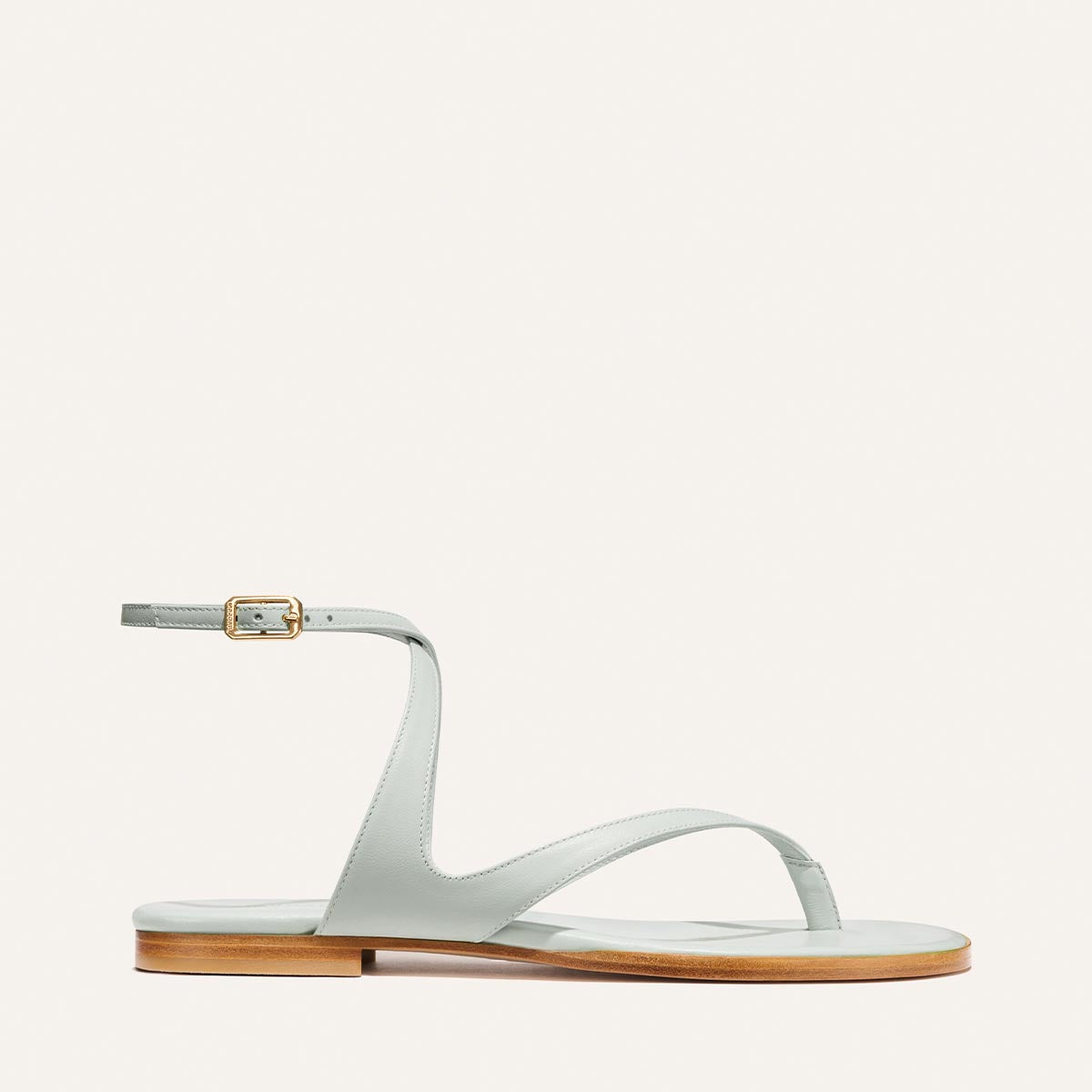 Light blue sandal with a thin strap on a white background