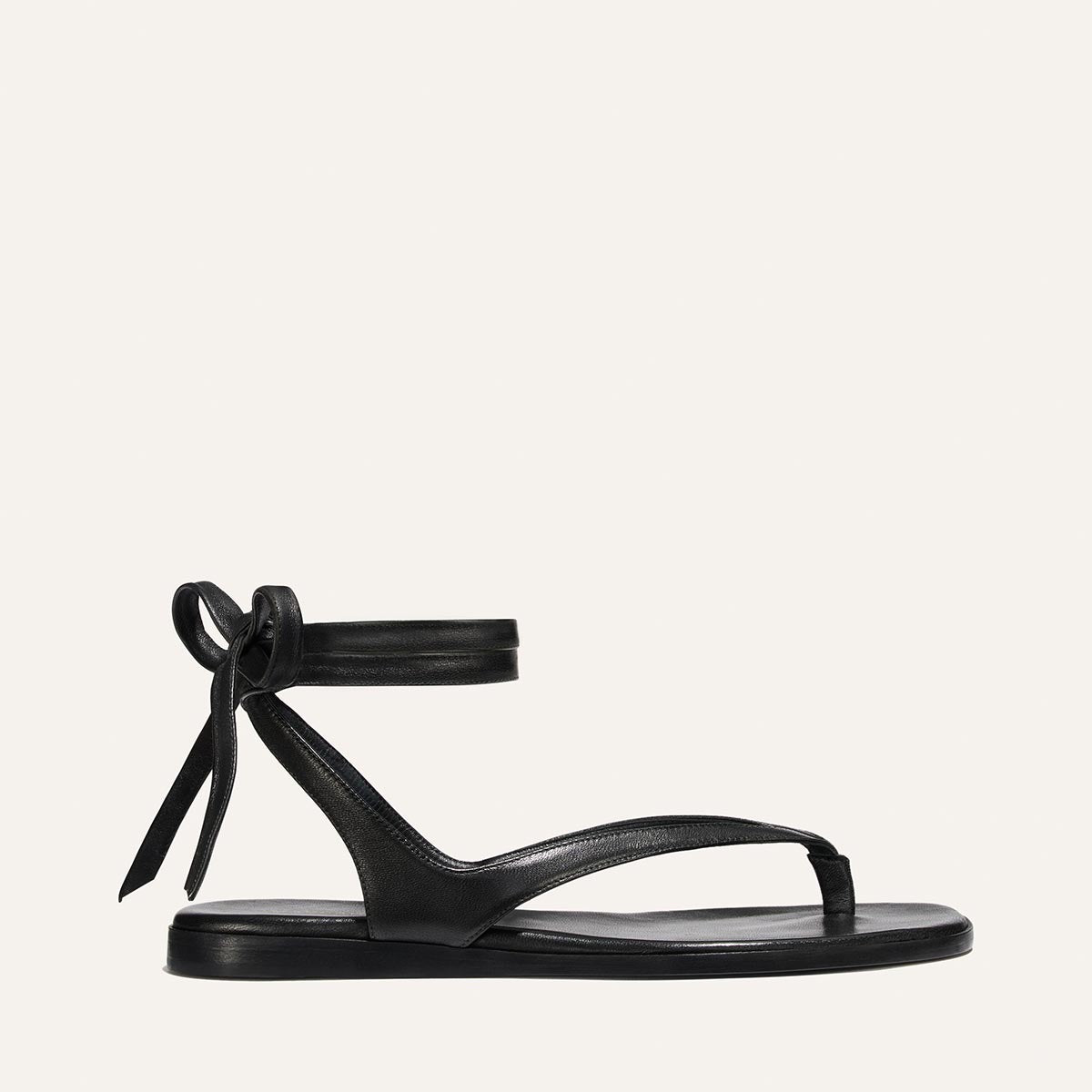 Black sandal with a bow on a white background