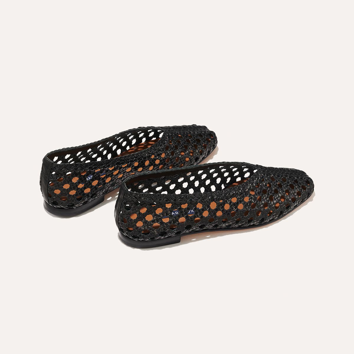 The Woven Paz in Black, featuring a handwoven Italian nappa leather upper with a flattering tapered toe and high vamp.
