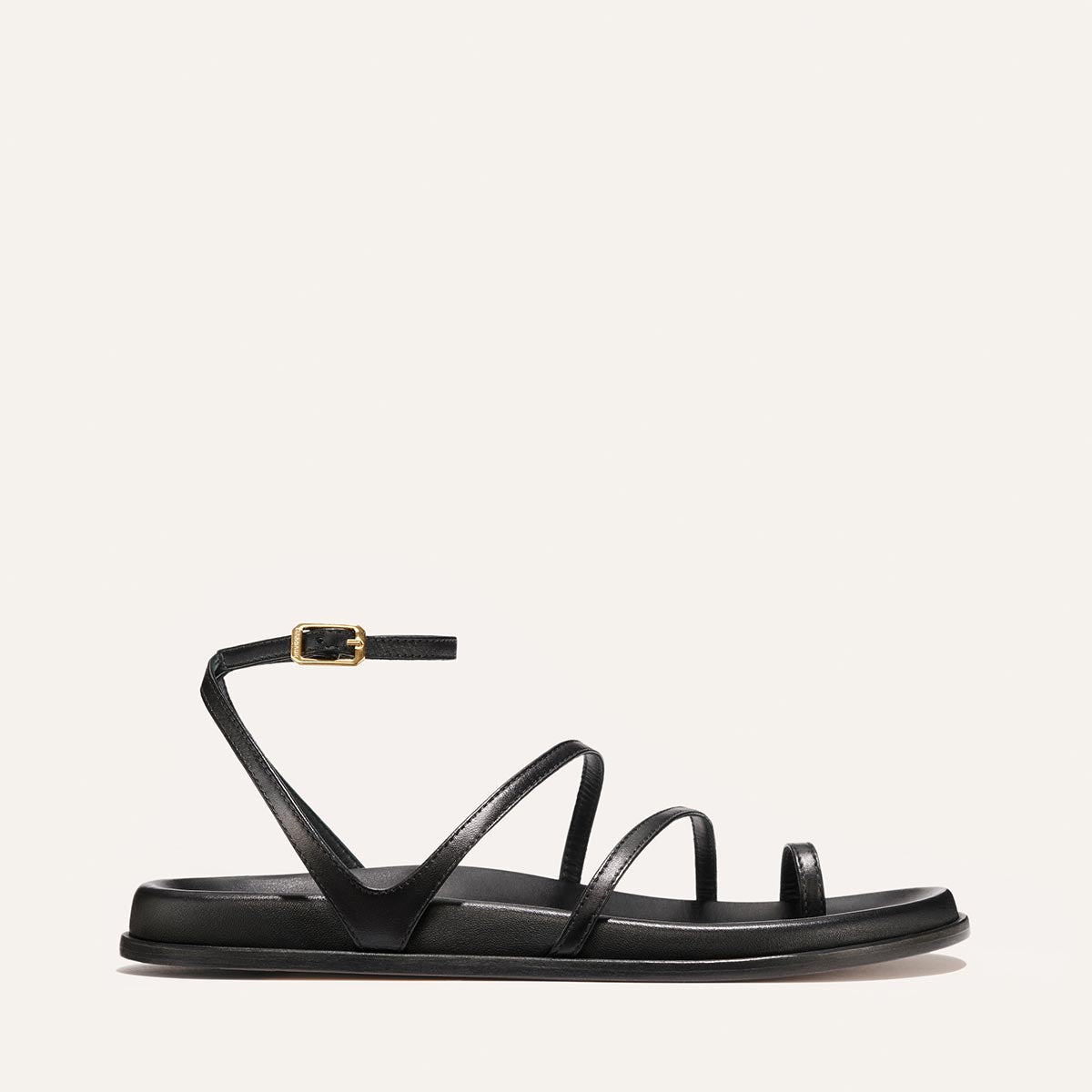 Black sandal with thin straps on a white background
