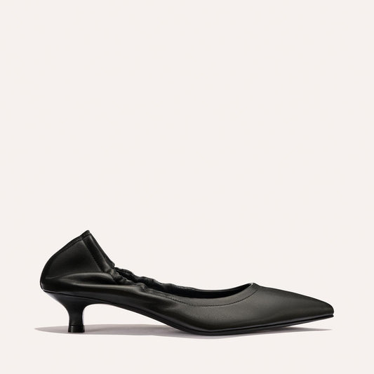 The Roma 40 - Black Nappa by Margaux is a chic black pointed-toe flat with a stylish heel and ruched top edge, shown against a plain light background.