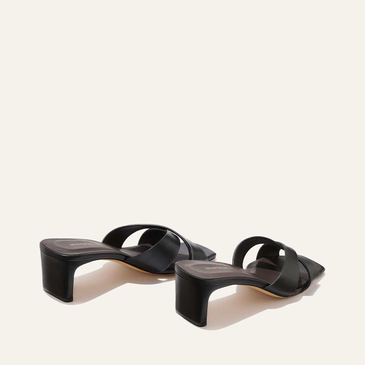 Black high-heeled sandals on a white background