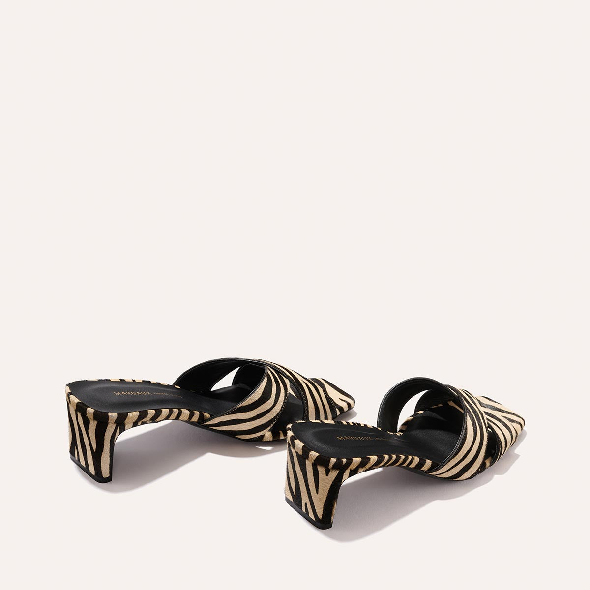 A pair of Margaux "The Selene 50 - Tan Zebra Haircalf" women's open-toe sandals with wide straps, chunky heels, and a tan zebra print pattern, shown on a plain light background.