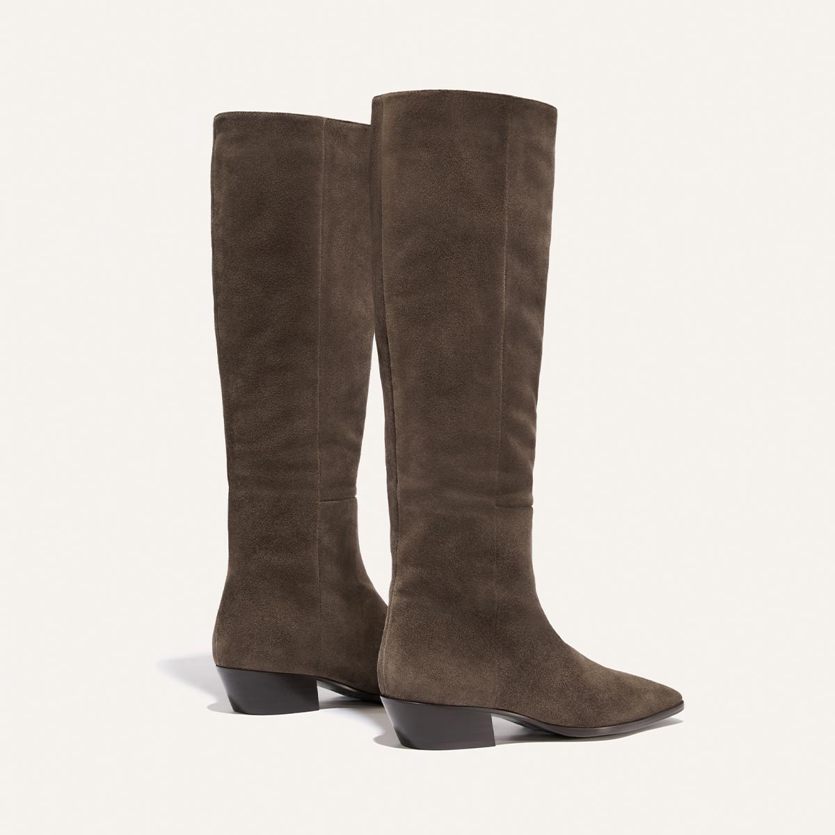 A pair of The Sierra Knee-High Boots in English Brown Suede by Margaux, featuring low block heels, displayed against a plain light background.